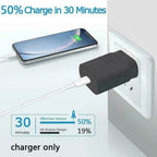 Black charger plugged into white outlet connected to smartphone showing charging screen and power comparison graph.
