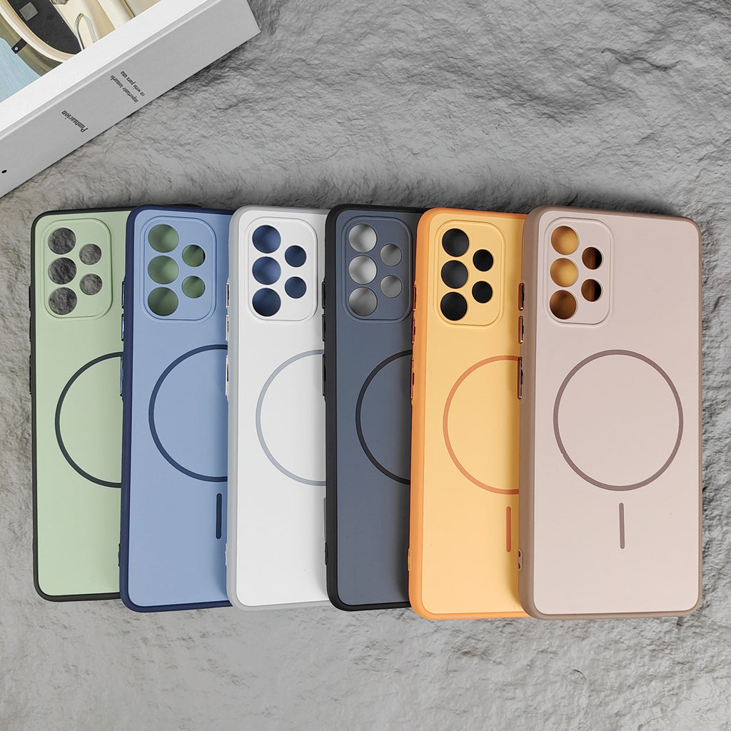 Fanned mint green and blue cases showing circular magnetic rings and camera cutouts on stone