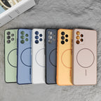 Fanned mint green and blue cases showing circular magnetic rings and camera cutouts on stone